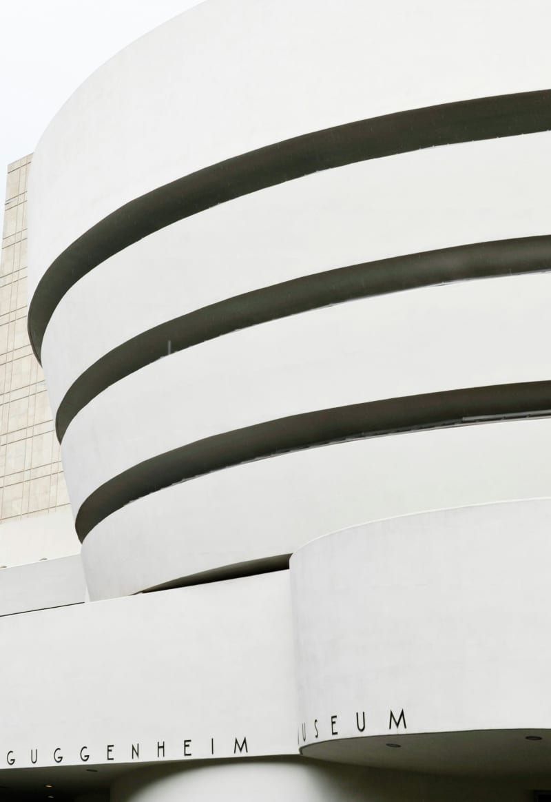 Exterior of the Guggenheim Museum in New York City, a unique spiral-shaped building designed by Frank Lloyd Wright.