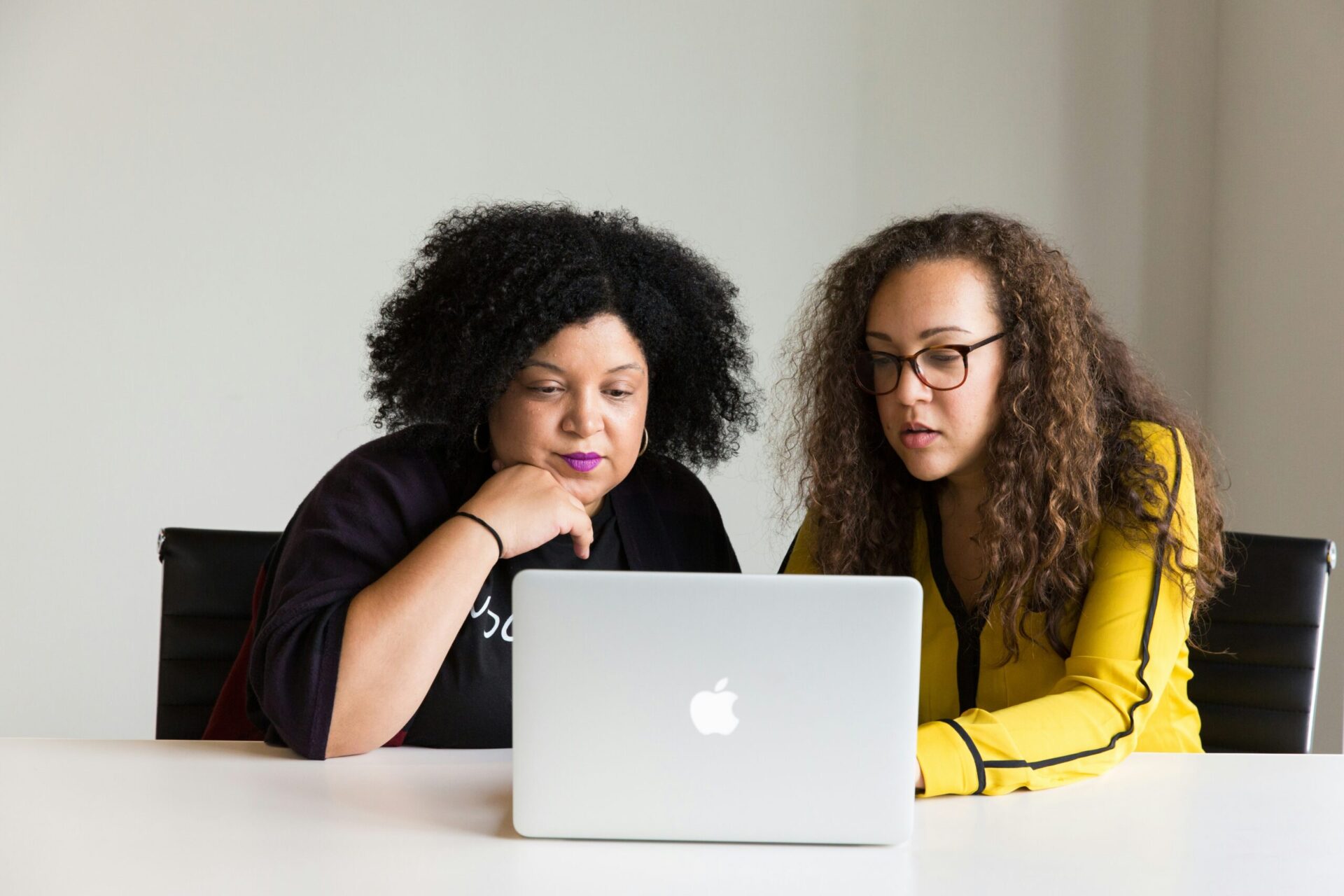 Two women looking at a laptop together