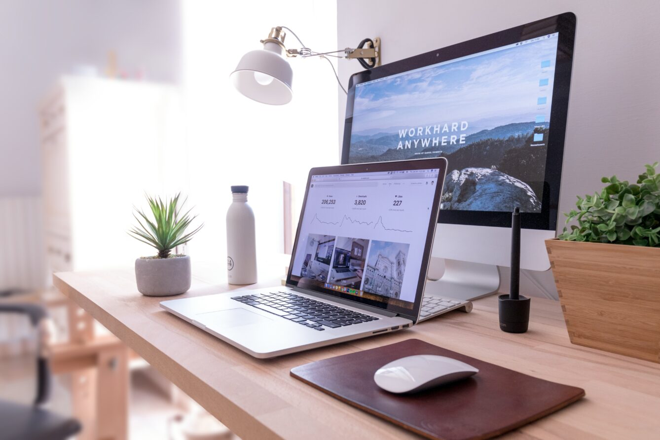 Desk showing a desktop computer and a laptop