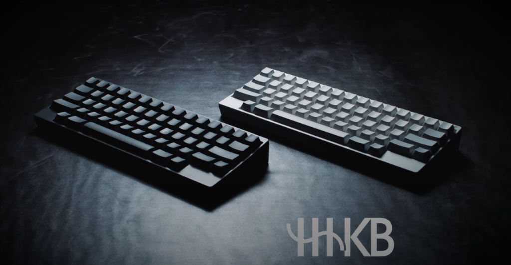 Two Happy hacking keyboards in white and black