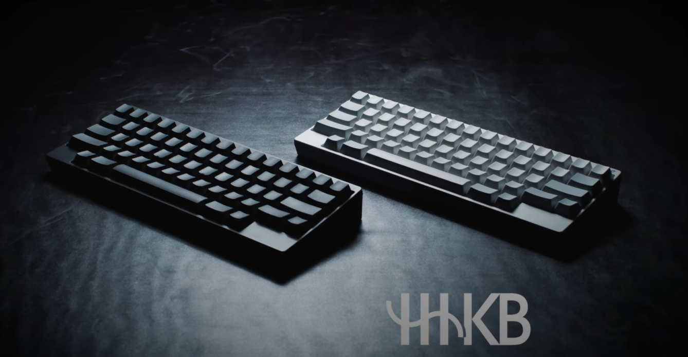 Two Happy hacking keyboards in white and black